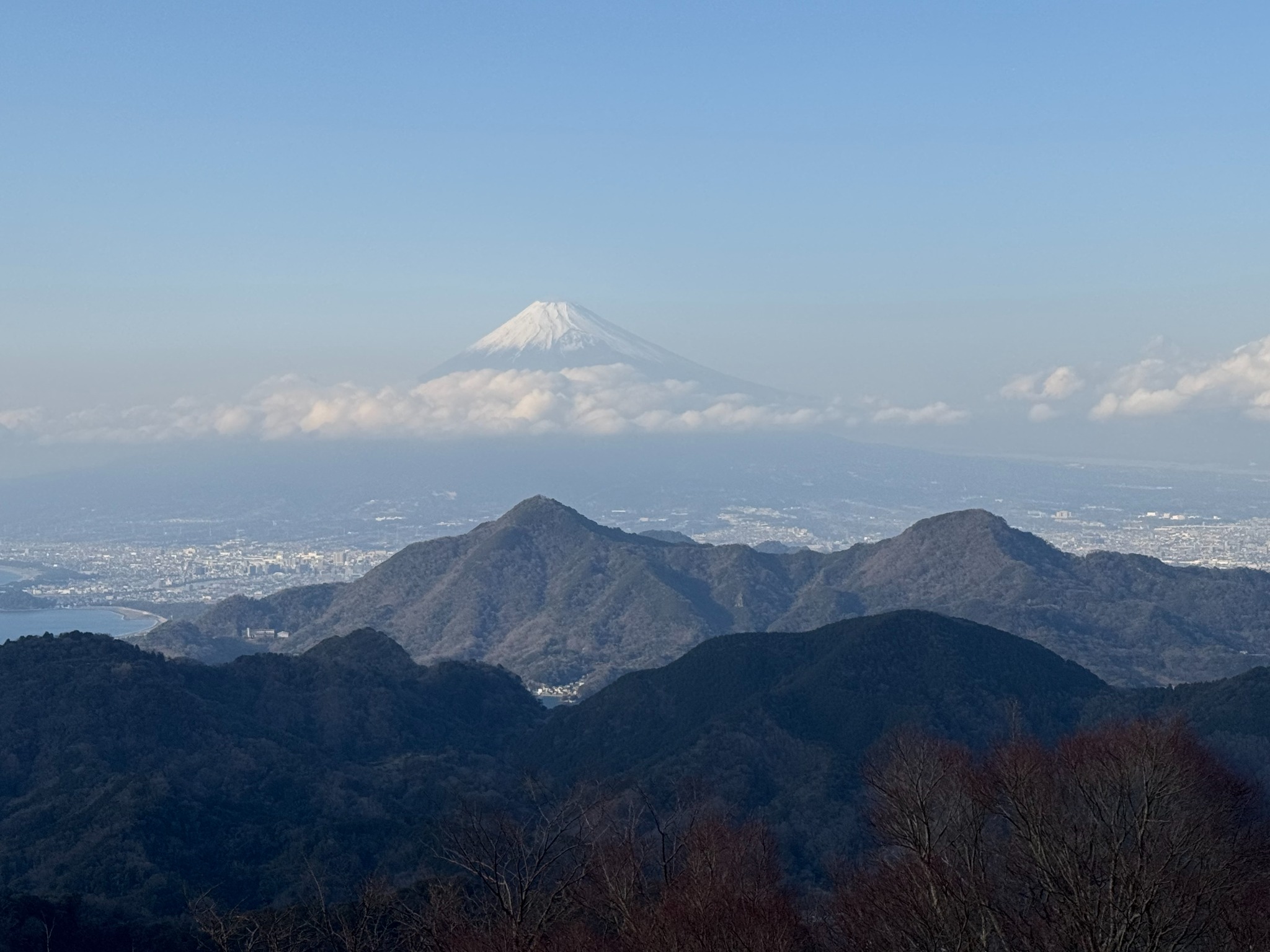 Mount Fuji rising above clouds and mountain ridges, seen from Izu Panorama Park